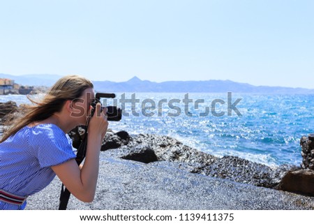 Woman photographer Nature photographer shooting the sea. Travel Concept.
