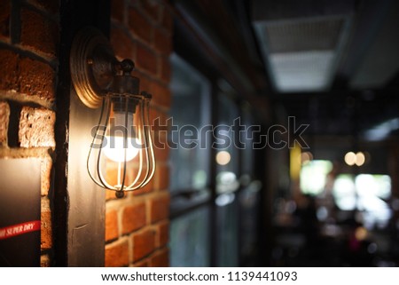 Antique electronic lamp, red wall lamp, high wall lamp, soft light.Red brick wall.Open chain, turn off the lights.hanging at the red brick wall in the building,Wall light brown brick,soft focus. Royalty-Free Stock Photo #1139441093