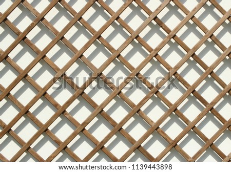 Geometric texture from garden. Wooden construction with shadows.