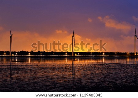 Turbines stand along the bank in the north of Taichung Port Bank under the twilight 