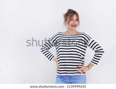 fashion. young woman in fashionable sweater and denim shorts on white background
