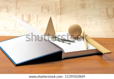 wooden geometric shapes and a notebook for recording