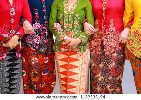 Close up details shot of southeast Asian woman in traditional Malay batik kebaya dress. Royalty-Free Stock Photo #1139535194