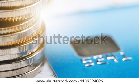 Close up coins and credit cards on account passbook.save money for business and financial concept.Saving retirement planning for family.
