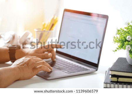 Cropped shot of man working with laptop.