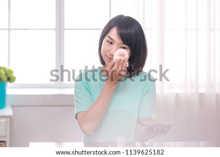 asian women make up her face in room