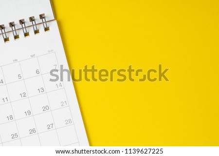 White clean calendar on solid yellow background with copy space, business meeting schedule, travel planning or project milestone and reminder concept. Royalty-Free Stock Photo #1139627225