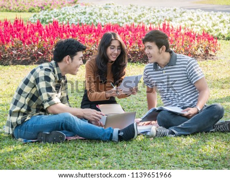 Group of college students with laptop and tablet computer while 