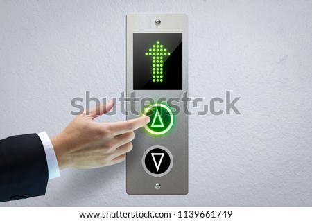 Hand of a man pressing the elevator button for next levels up in concept of more advance to a success. Royalty-Free Stock Photo #1139661749