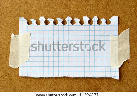 sheet of torn paper on the board