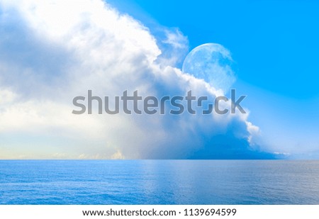 Full moon shining in the sky with dramatic clouds background and sea "Elements of this image furnished by NASA "