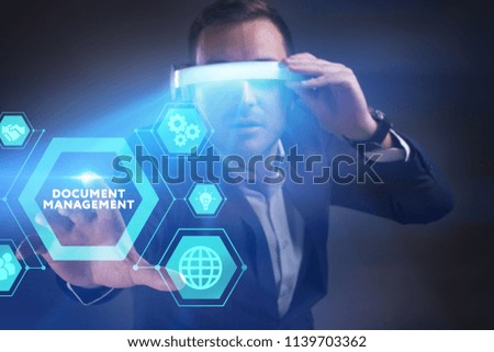 Business, Technology, Internet and network concept. Young businessman working in virtual reality glasses sees the inscription: Document management
