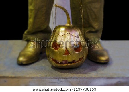 golden pumpkin with ropes standing on the floor, background image