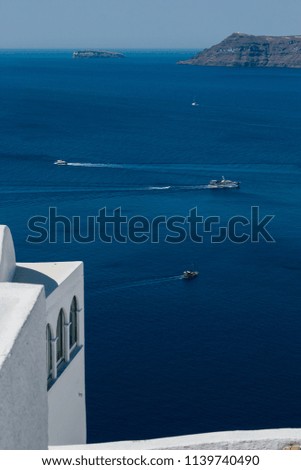 View of the sea and the caldera of Santorini, in the picture we can see some boats and their route