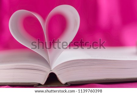Open a book with a heart shape from the pages of the book