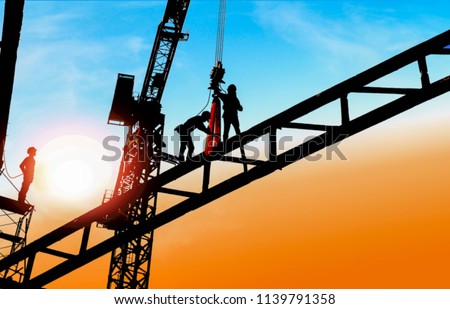 silhouette of construction worker with tower crane Royalty-Free Stock Photo #1139791358