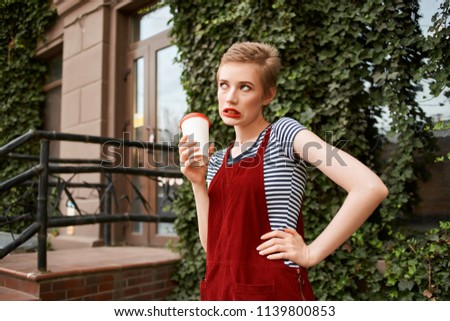  woman with coffee walk around the city                              
