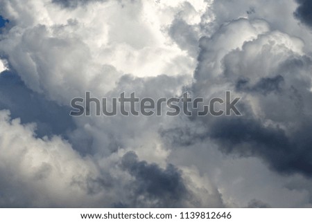 Storm cumulus clouds, gray sky in rain, bad weather background, autumn season.