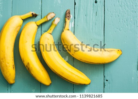 ripe bananas on blue wooden table