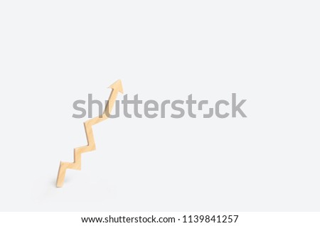Wooden arrow graphic shows up on a white background. The concept of growth and development, increasing efficiency and quality. Minimalism. Success in business and personal life.