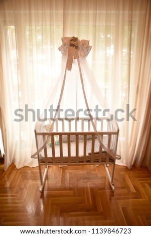 Baby cot by the window