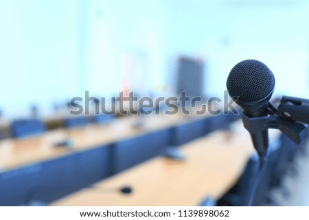 Close-up of black microphone in meeting room There is a conference table in the background selective focus and shallow depth of field