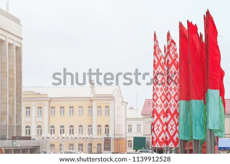 Belarussian flags in the city under grey air. Suitable for any purprose use.