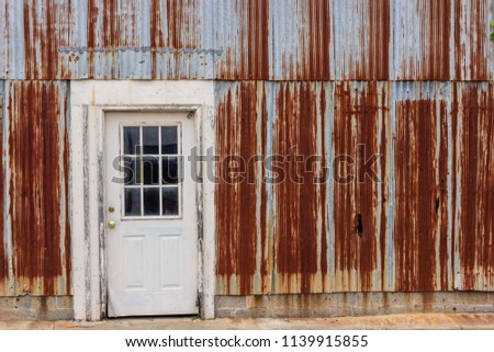 Rusted Corrugated Steel Wall and White Door