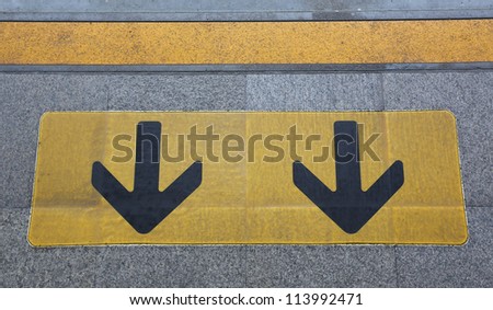 The Sign of yellow arrow on floor