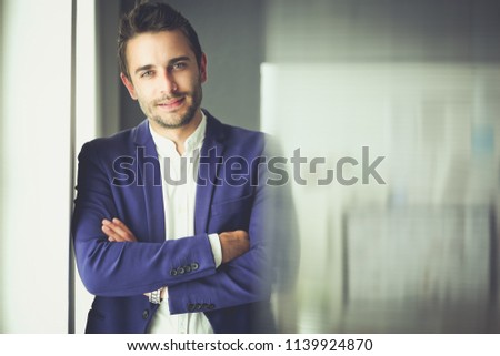 Portrait of young designer in front of laptop and computer while working