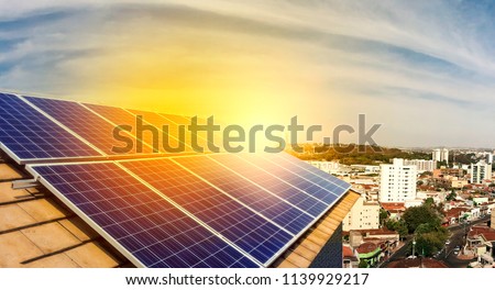 Photovoltaic power plant on the roof of a residential building on sunny day - Solar Energy concept of sustainable resources Royalty-Free Stock Photo #1139929217