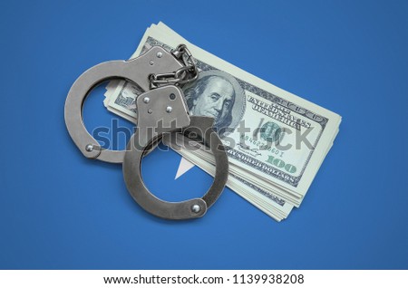 Somalia flag  with handcuffs and a bundle of dollars. Currency corruption in the country. Financial crimes