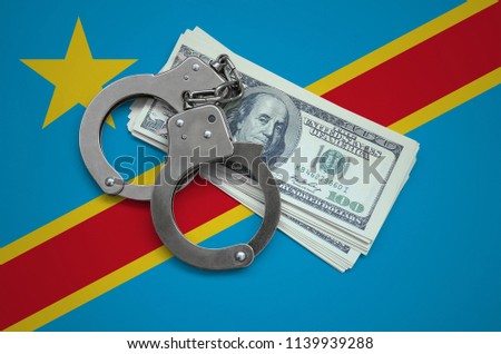 Democratic Republic of the Congo flag  with handcuffs and a bundle of dollars. Currency corruption in the country. Financial crimes