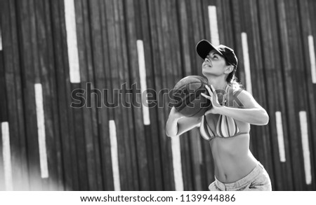 Young woman basketball player training outdoors on a local court