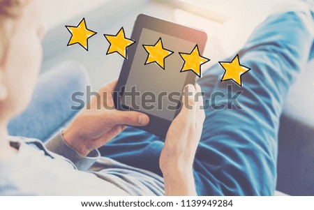Five Star Rating with man using a tablet in a chair