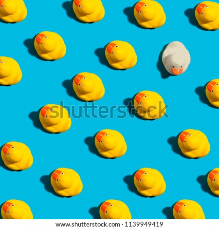One out unique rubber duck concept on a blue background
