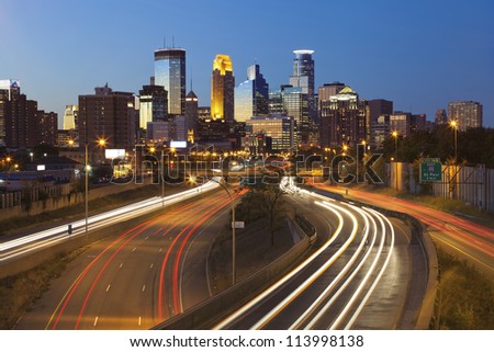 Minneapolis. Image of Minneapolis skyline and highway with traffic lines leading to the city.