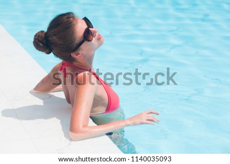 young beautiful woman in bikini relaxing in spa pool