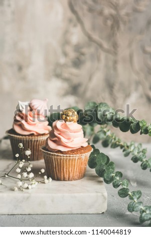 Cupcakes with buttercream on marble board. Luxury wedding or birthday cupcakes. Toned image