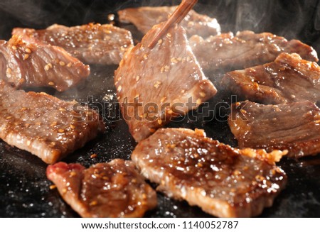 Yakiniku is the food that grille a thin sliced beef and dipped in a soy-bean sauce based sauce Royalty-Free Stock Photo #1140052787