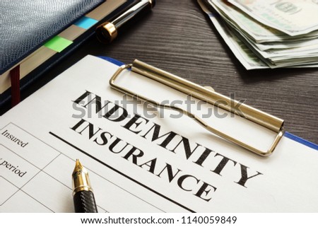 Indemnity insurance policy on the table. Royalty-Free Stock Photo #1140059849