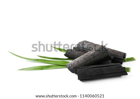 Natural wood charcoal on white background Royalty-Free Stock Photo #1140060521