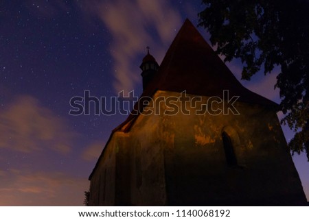 Old chapel in the village of Dobronice, under the night starry sky. Dobronice u Bechyne. Czech Republic.