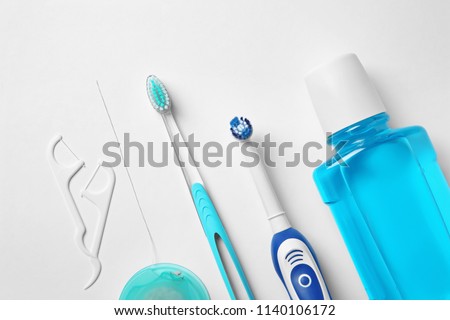 Flat lay composition with toothbrushes and oral hygiene products on white background Royalty-Free Stock Photo #1140106172