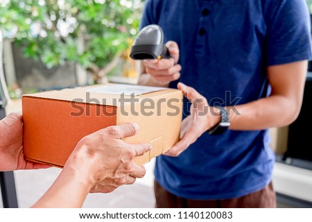 Delivery service courier driver driving with with boxes in hands. Delivery concept.
