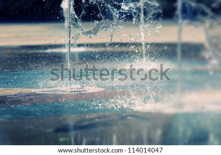 Water stream splashing on ground Royalty-Free Stock Photo #114014047