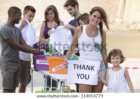  volunteer group saying thank you for clothing donation Royalty-Free Stock Photo #114014779