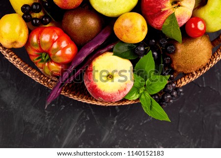 Healthy colorful food selection: fruit, vegetable, superfood,  leaf in basket on dark background. Clean eating. Vegan. Detox. Supermarket product. Assortment Fresh Organic. Natural Concept 