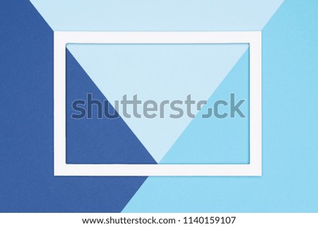 Abstract geometrical flat lay pastel blue colored paper background. Minimalism, geometry and symmetry template with empty picture frame mock up.