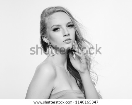 Blonde long hair woman beauty portrait with beautiful hairstyle isolated on white monochrome